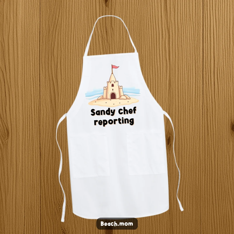 Funny apron adorned with a cheerful sandcastle waving a flag at the ocean, making cooking a beachy, humorous experience.