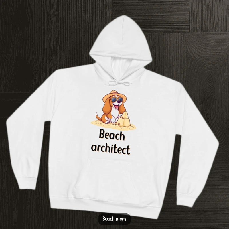 Funny Basset Hound Beach Hoodie: A happy Basset hound builds a sandcastle, wearing beach gear, offering cozy summer vibes, funny gift.