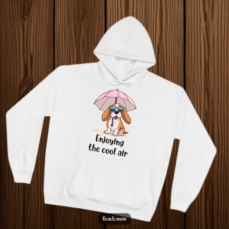Funny Basset Hound hoodie featuring a dog under a tiny umbrella, enjoying the beach breeze, ideal for cozy relaxation.