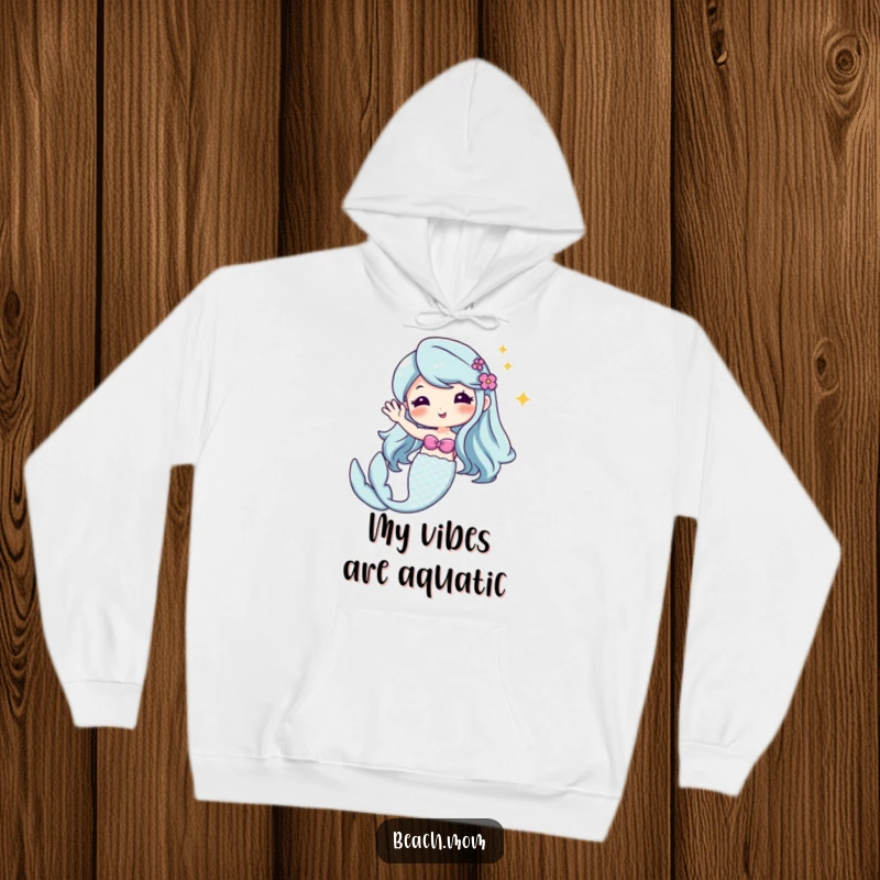 Funny Kawaii mermaid hoodie, cute cartoon character with a glittery tail, waving hello, cozy and magical.