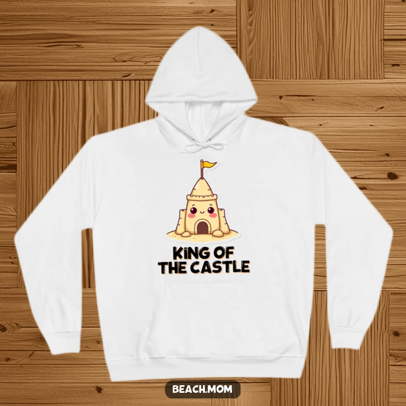 Funny sandcastle character hoodie with a small flag, looking extremely cheerful and ready for cozy beach days, a fun gift.
