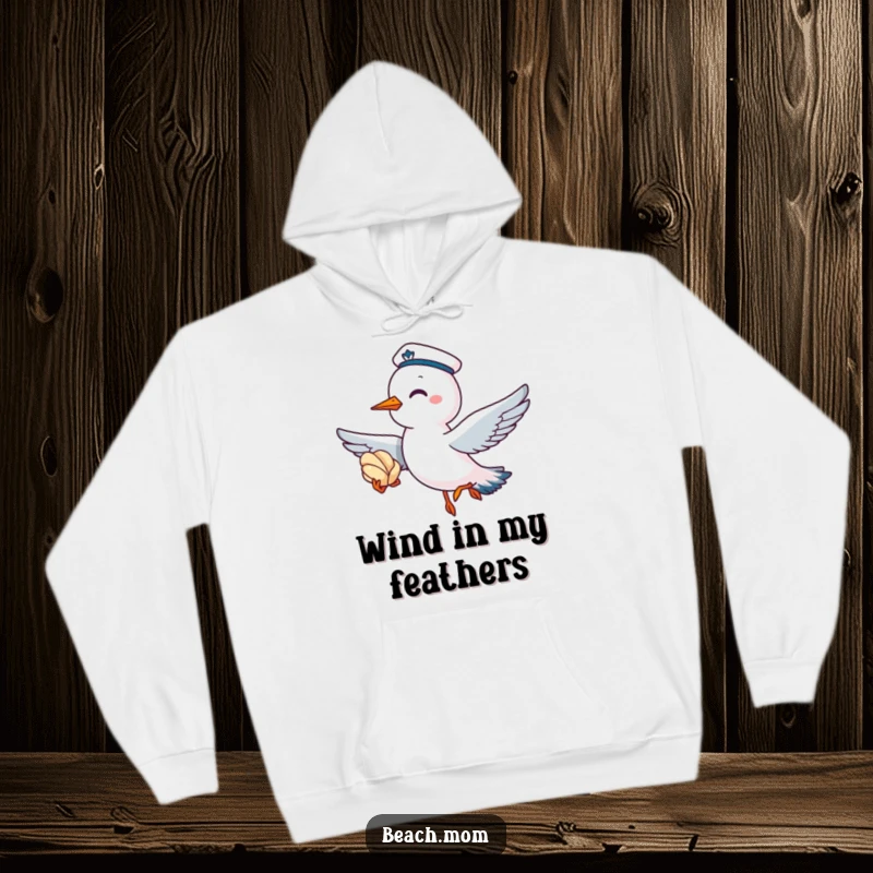 Funny hoodie with a giggling seagull wearing a sailor cap, flying with a seashell, perfect for cozy seaside vibes.