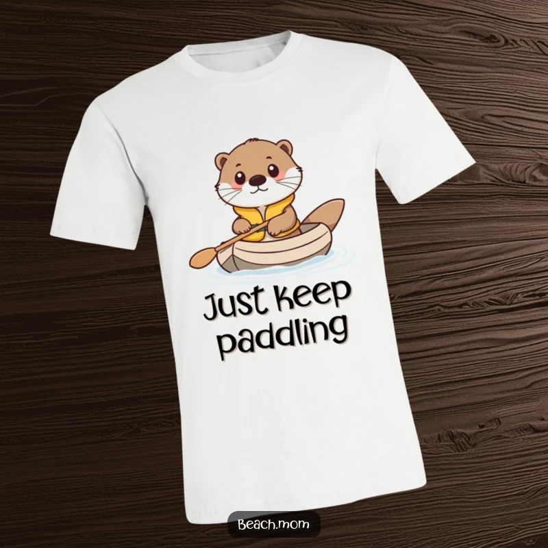 Funny t-shirt showcasing a cute otter wearing a life vest, joyfully paddling a tiny raft, perfect for animal lovers.