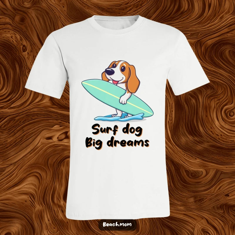Funny Basset Hound t-shirt featuring an excited dog holding a surfboard, ready to paddle out into the sea.